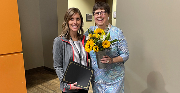 Women smiling and holding flowers