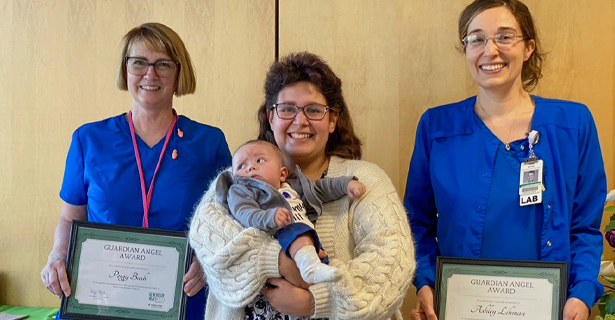 Providers, mother and infant smiling