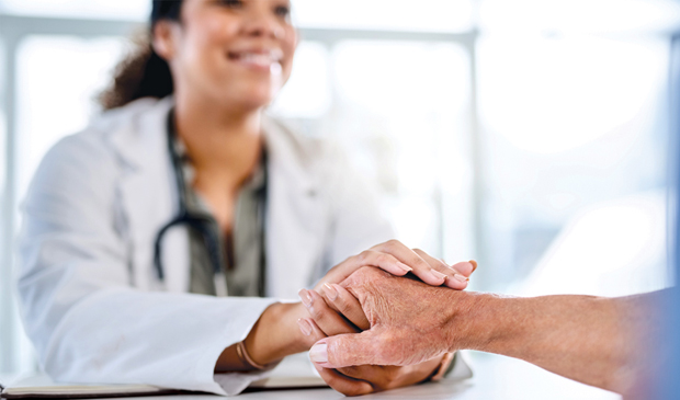 Provider holding patient's hand