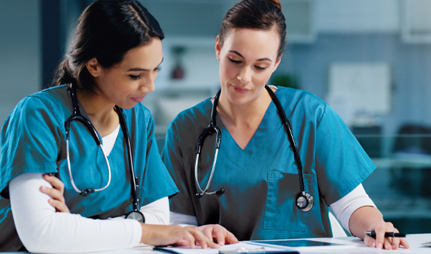 nurses working in teal scrubs