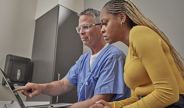 Physician and patient looking at computer screen