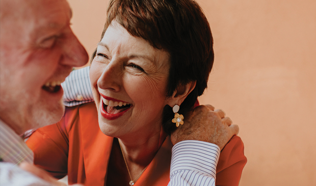 Older couple looking at eachother and laughing