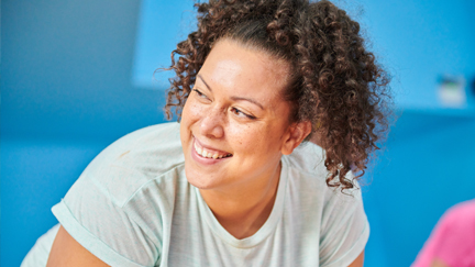 Woman smiling while she does exercise