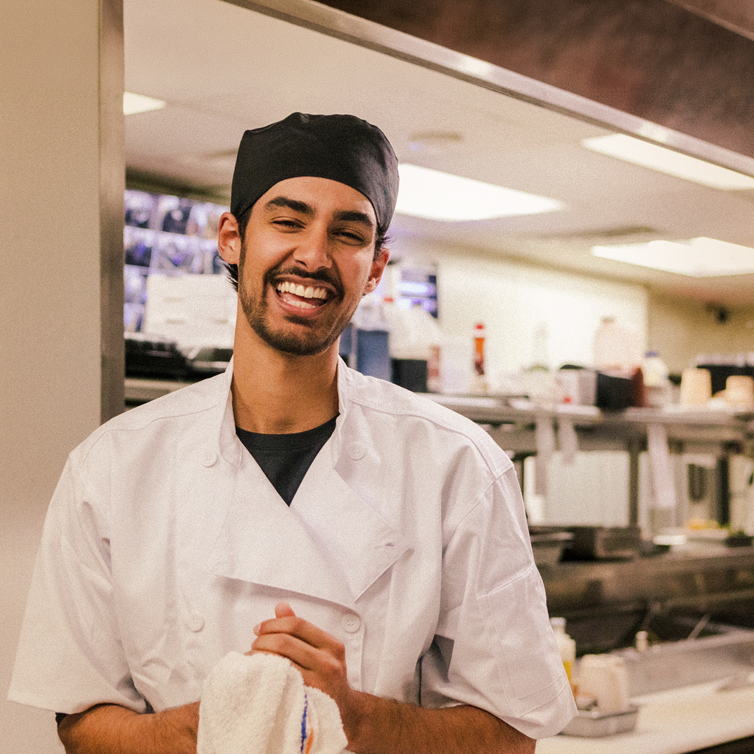 Male chef smiling in kitchen