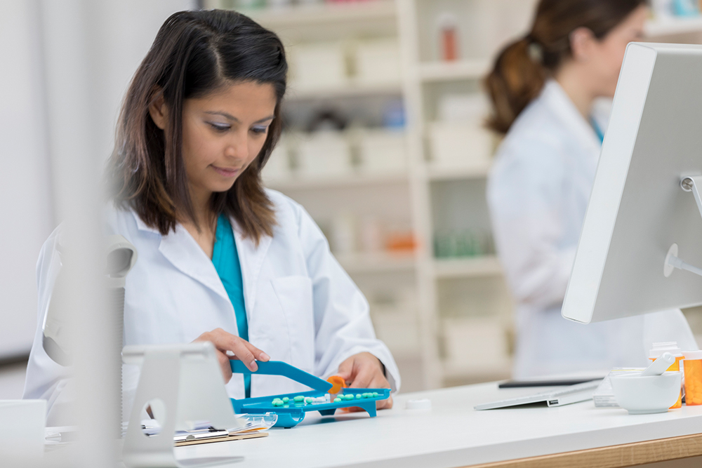 Pharmacist counting pills